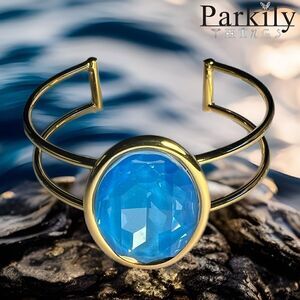 A Gold Handcrafted bracelet with large oval blue Swarovski crystal